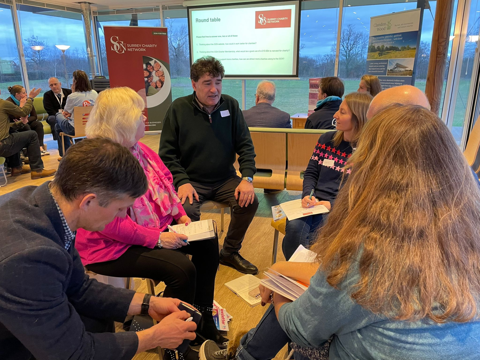 Attendees taking part in a round-table discussion at a SCN event