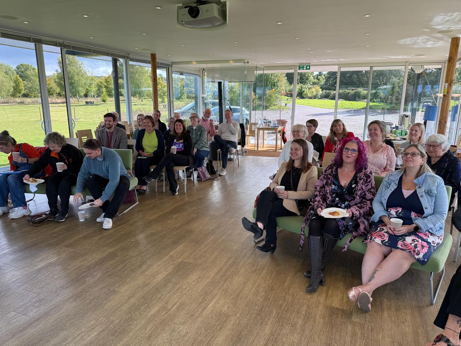 The Surrey Charity Network community seated together at Clandon Wood