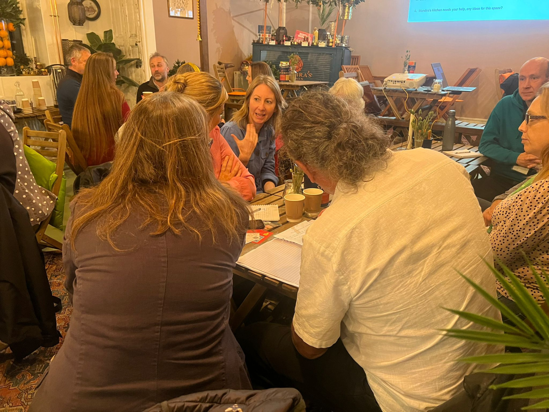 Charity professionals sharing ideas over coffee at a SCN meet-up
